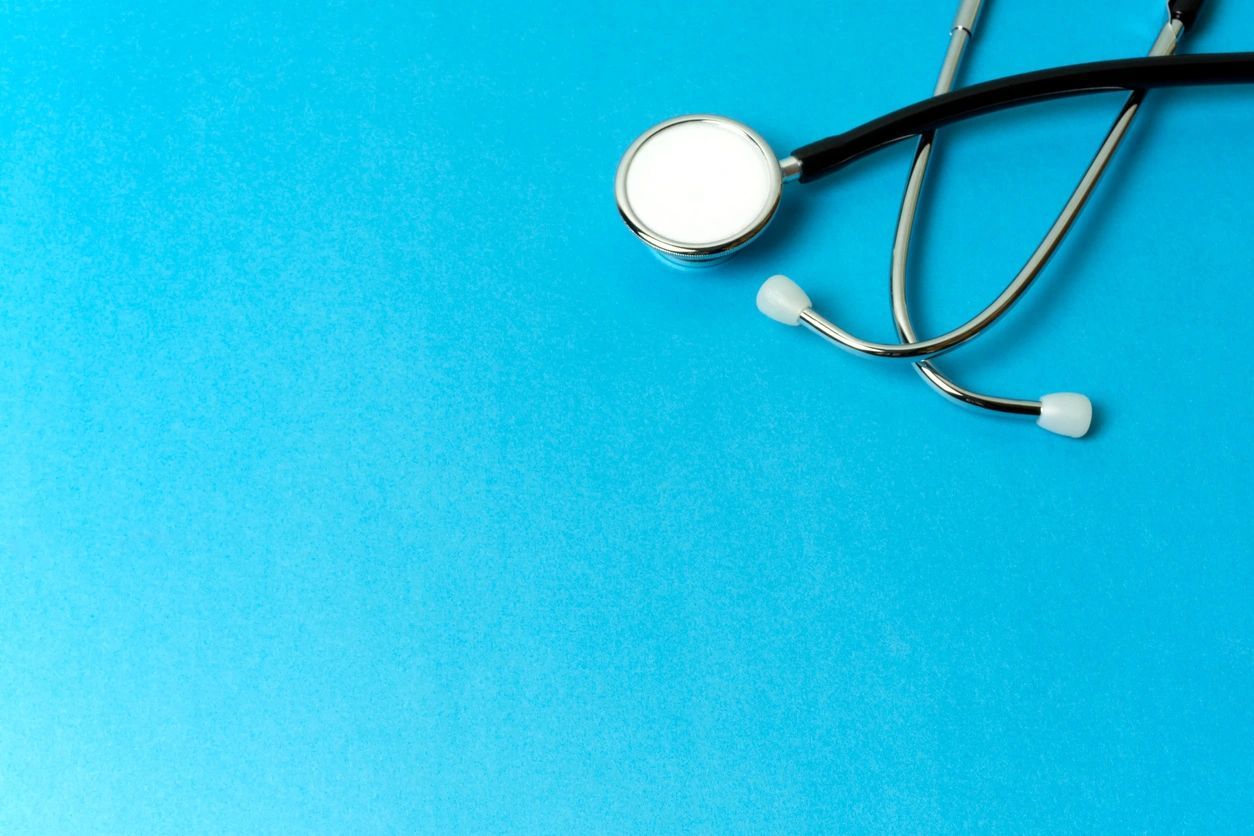 A stethoscope on top of a blue table.